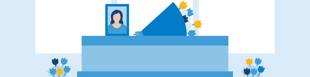 Een kist van een overleden persoon met daarom bloemen en een foto